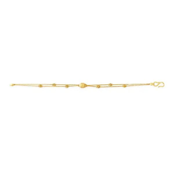 Yellow gold carved bead bracelet laid flat with lobster clasp at end