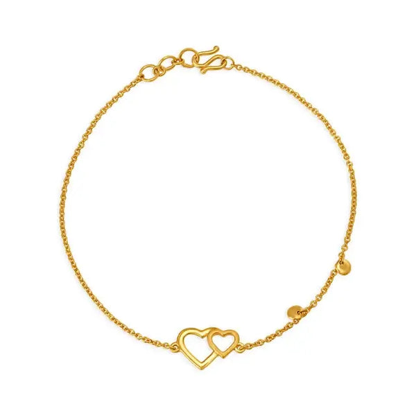 Gold heart bracelet with double heart charm on center link chain