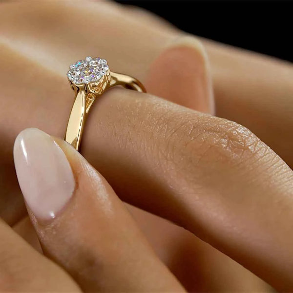 Yellow gold diamond cluster ring on a hand, solitaire-style center stone