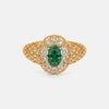Gold filigree ring with oval green center stone and diamond halo, openwork basket