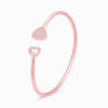 Rose gold heart bracelet with dual heart charms and pavé detail on curved cuff