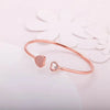 Rose gold heart bracelet with two heart charms, one pavé and one with small crystal