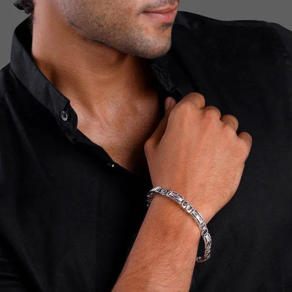 Silver link bracelet on wrist with repeating rectangular links and box clasp