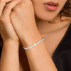 Silver pavé bracelet with round center charm on wrist, close-up