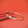 Silver sparkly bangle bracelet with round charm and pavé detail