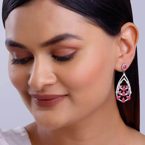 Silver drop earrings on model with pink teardrop stones and crystal details, side view