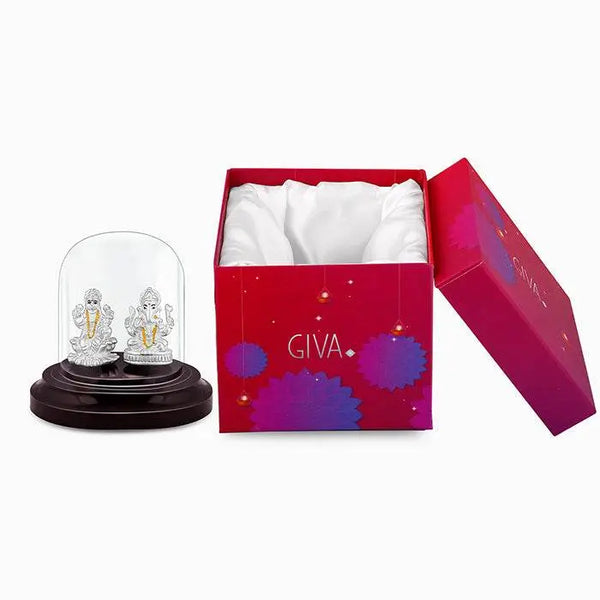 Silver Lakshmi and Ganesha idol under glass dome with red gift box.