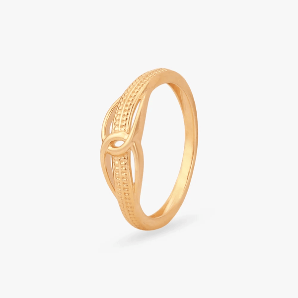 Gold ring with knot-like openwork and textured dotted detailing, slim band