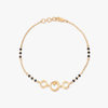 Gold circle-link bracelet with black bead accents and round clasp detail