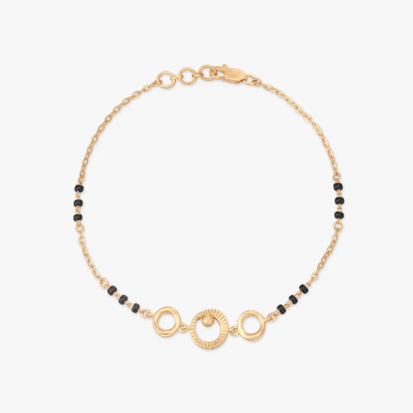 Gold circle-link bracelet with black bead accents and round clasp detail