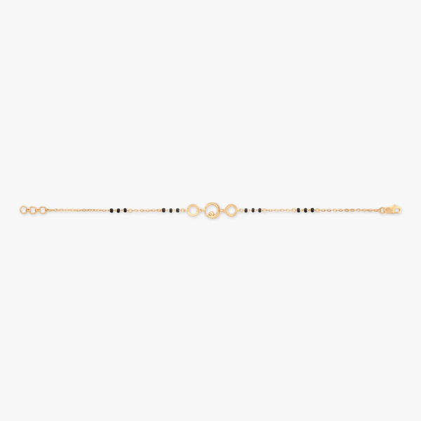 Gold chain bracelet with black bead strand and round link clasp