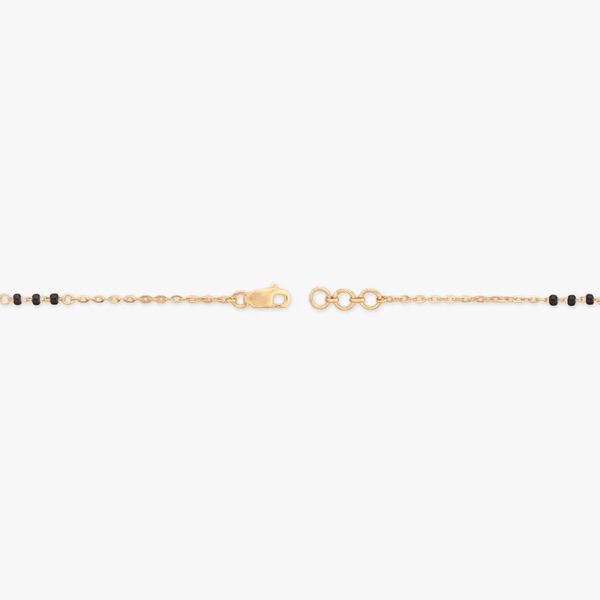 Gold bracelet end view with black beads and round clasp links
