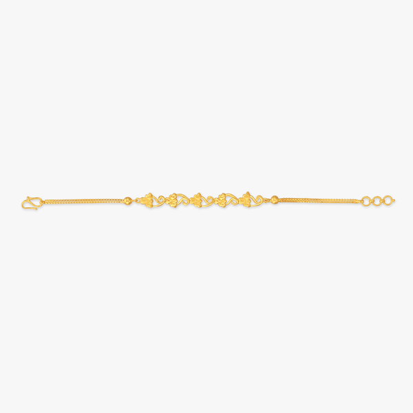 Gold vine charm bracelet laid flat, with toggle clasp and repeating ornamental links