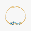 Blue enamel butterfly charm bracelet on gold-tone chain with toggle clasp.