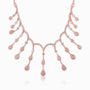 Rose gold fringe necklace with small heart and teardrop charms in an arc