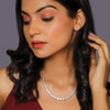 Silver-tone gemstone tennis necklace with pavé stone row, worn on model
